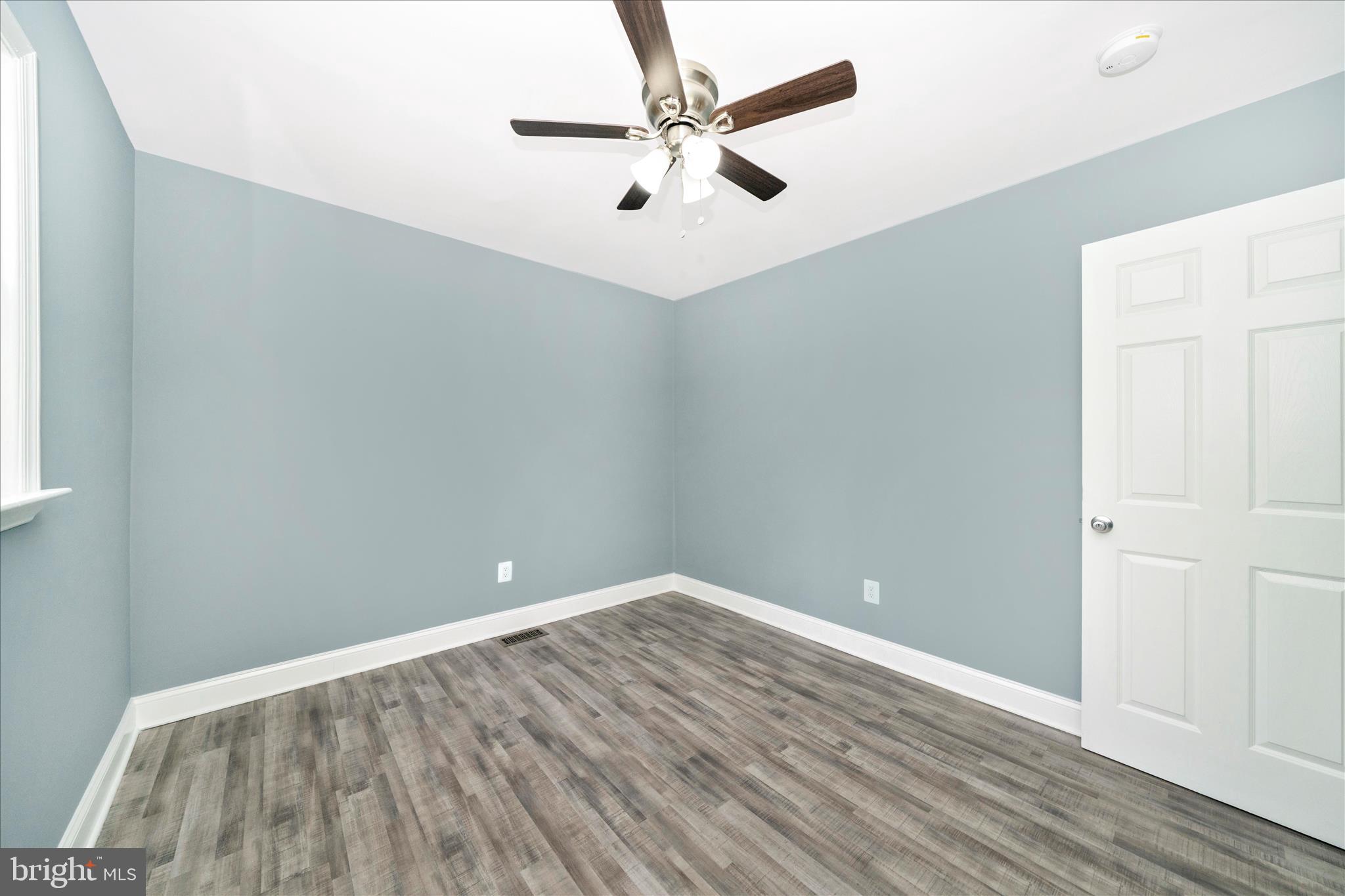 6737 Allentown Road Temple Hills, MD 20748 - Photo 41 of 51 wooden floor in an empty room with a window