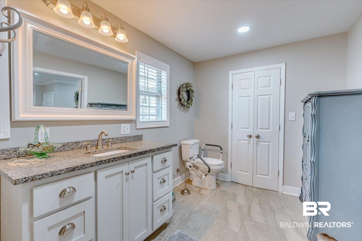 14160 Moffett Road Wilmer, AL 36587 - Photo 25 of 75 Full bathroom featuring toilet, vanity, and baseboards