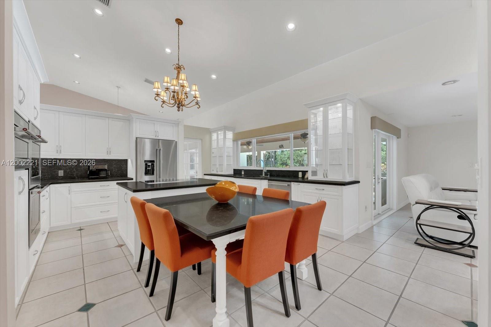 9941 Southwest 143rd Street Miami, FL 33176 - Photo 12 of 48 Large light and bright kitchen with a cooking island and breakfast bar/table