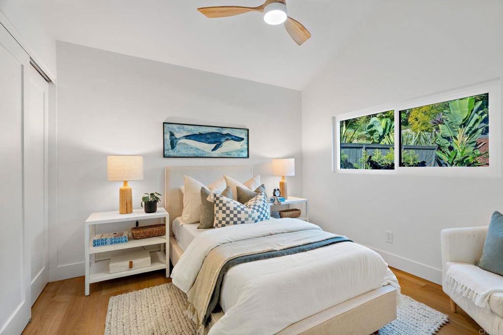 411 Gardendale Road Encinitas, CA 92024 - Photo 20 of 28 a bedroom with a bed and a large window