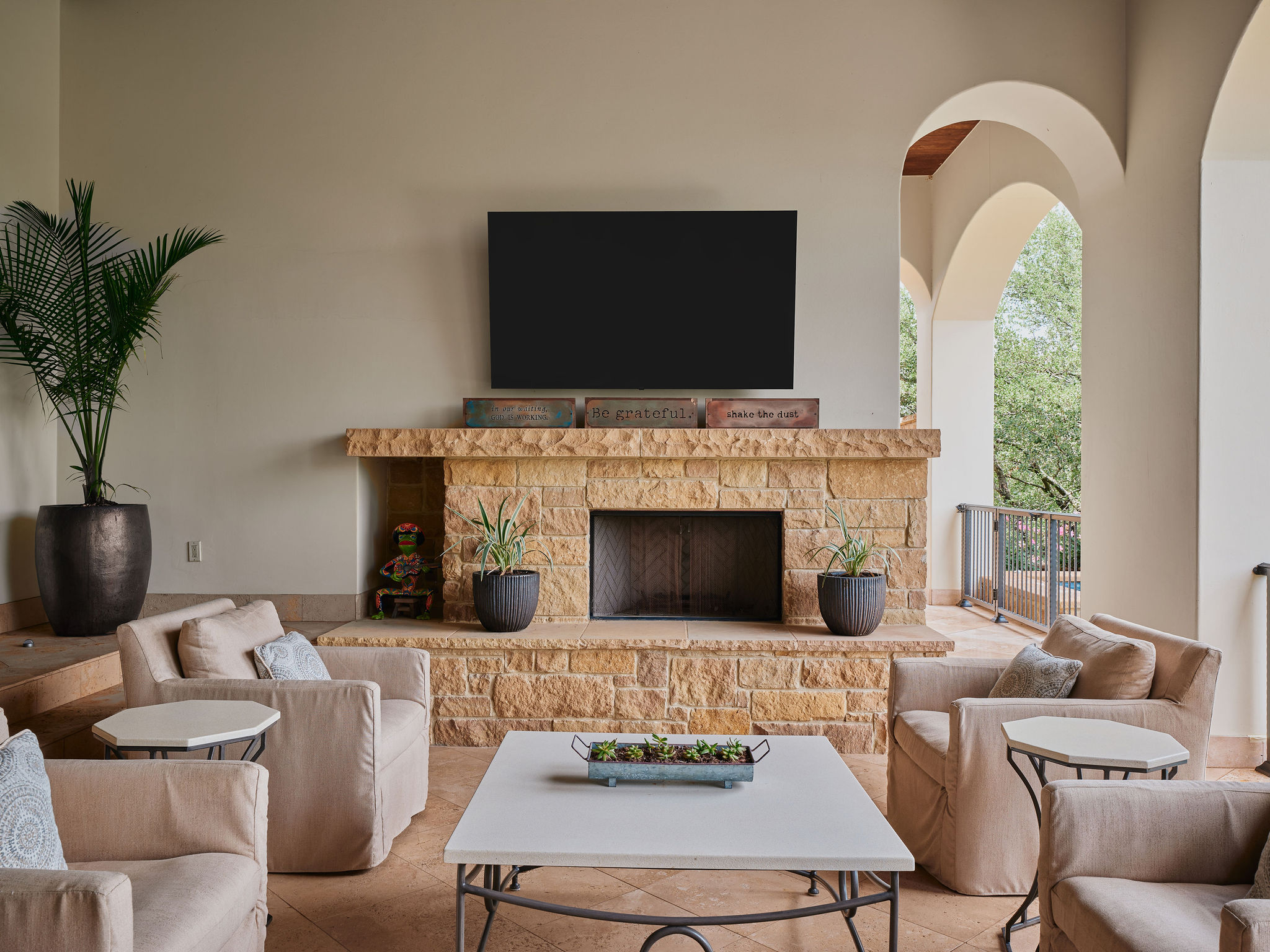 433 Brandon Way Austin, TX 78733 - Photo 24 of 40 An inviting stone fireplace provides a focal point in this comfortable covered patio, ideal for relaxed gatherings.