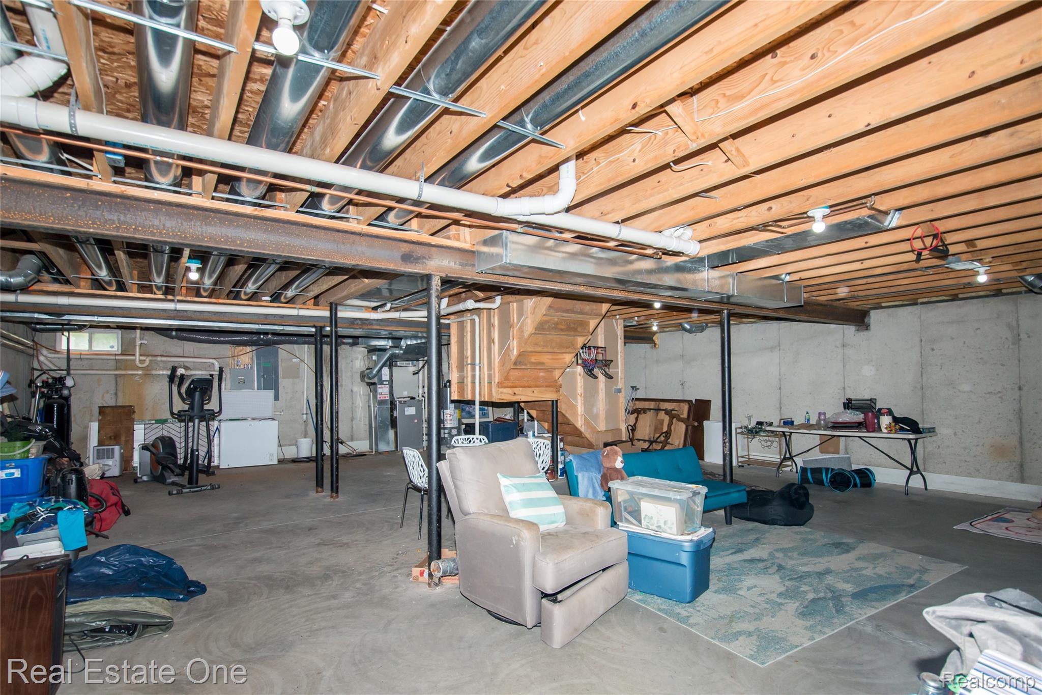 145 Stockbridge Road South Webberville, MI 48892 - Photo 28 of 35 Expansive unfinished basement featuring concrete flooring, exposed wood joists, and concrete foundation walls