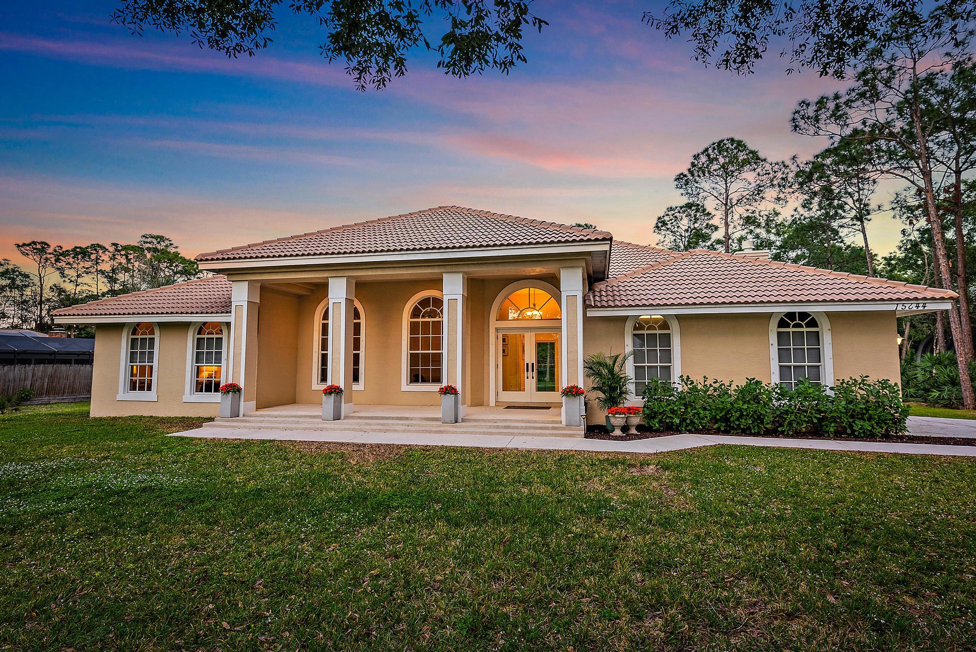 15644 Billy Goat Lane Jupiter, FL 33478 - Photo 1 of 39 front view of a house with a yard