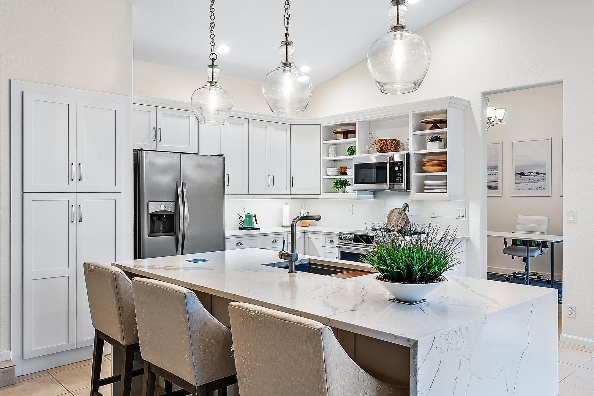 15644 Billy Goat Lane Jupiter, FL 33478 - Photo 21 of 39 a kitchen with stainless steel appliances granite countertop a sink and a refrigerator