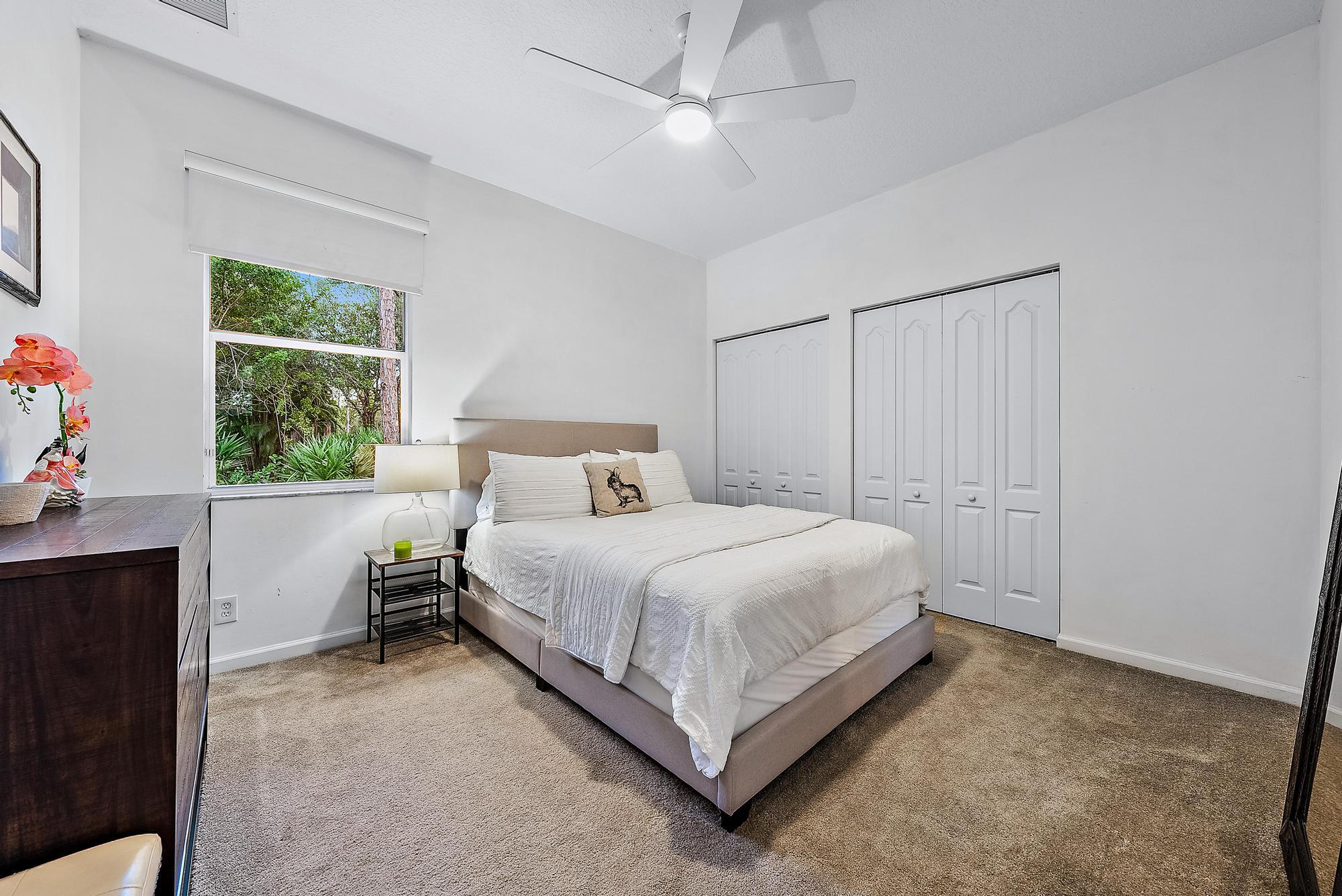 15644 Billy Goat Lane Jupiter, FL 33478 - Photo 23 of 39 a bedroom with a bed and a window