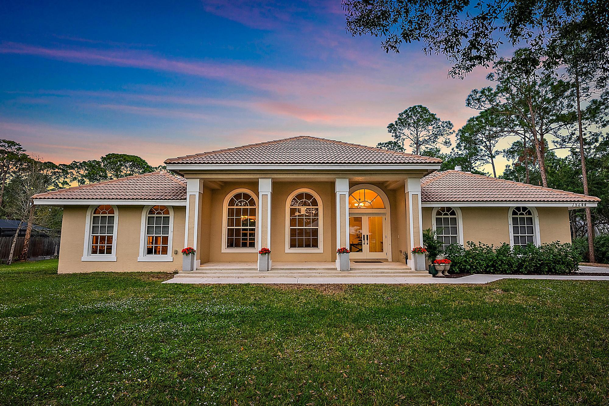 15644 Billy Goat Lane Jupiter, FL 33478 - Photo 33 of 39 a front view of a house with garden