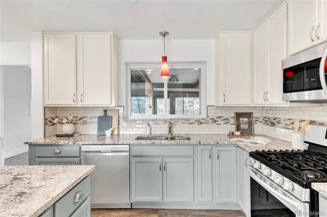 a kitchen with a sink stove top oven and cabinets