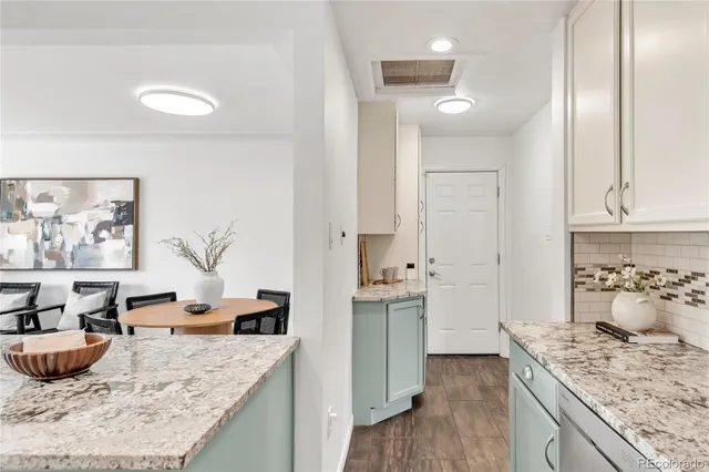 a large kitchen with kitchen island a stove a sink and a refrigerator