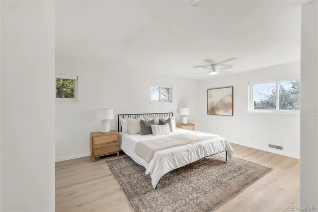 a bedroom with a bed and a night stand