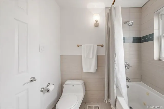 a bathroom with a shower and toilet