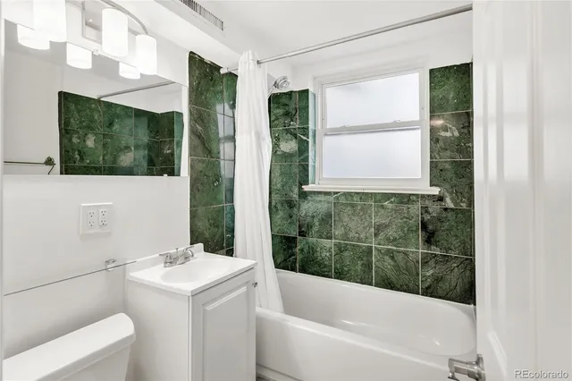 a bathroom with a tub sink and window