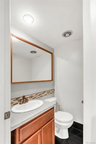 a view of a yard in front of a house with large trees