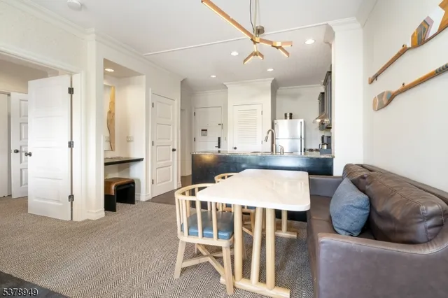 a living room with furniture a fireplace and a chandelier