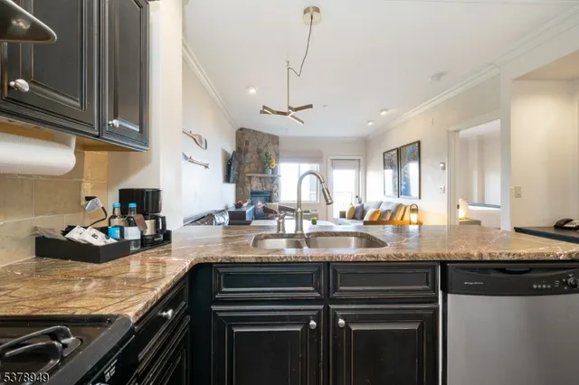 a kitchen with a sink a stove and cabinets