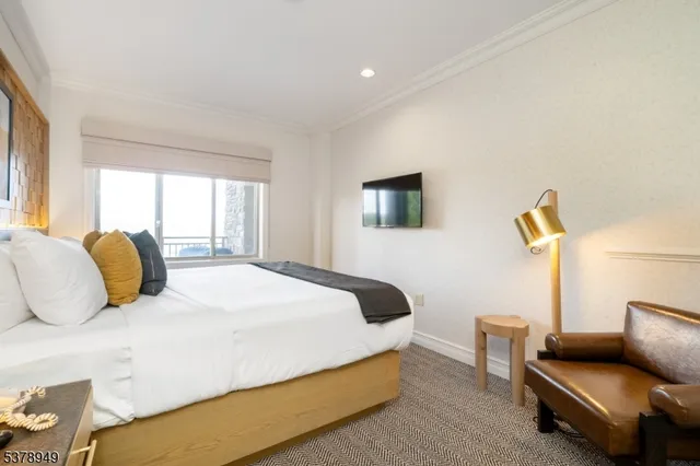 a bedroom with a bed and a couch