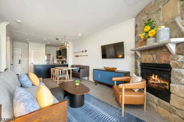 a living room with furniture a fireplace and a flat screen tv