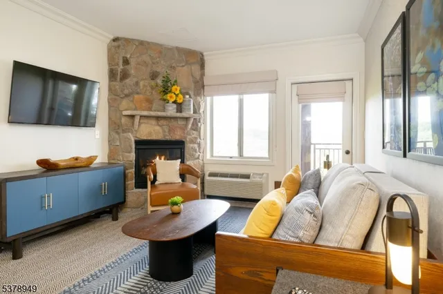a living room with furniture fireplace and window