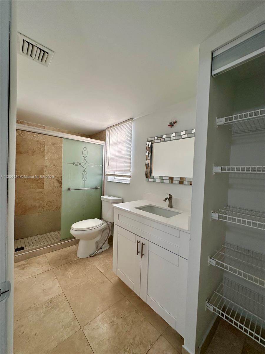 603 South State Road 7, Unit 1E Margate, FL 33068 - Photo 5 of 8 a bathroom with a sink toilet and shower