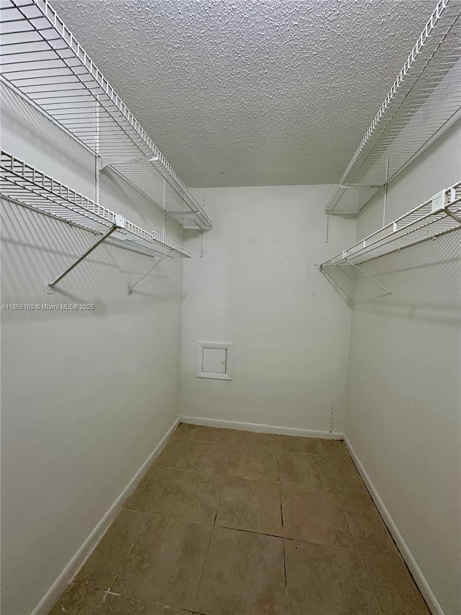 603 South State Road 7, Unit 1E Margate, FL 33068 - Photo 6 of 8 a view of a room with racks on the wall