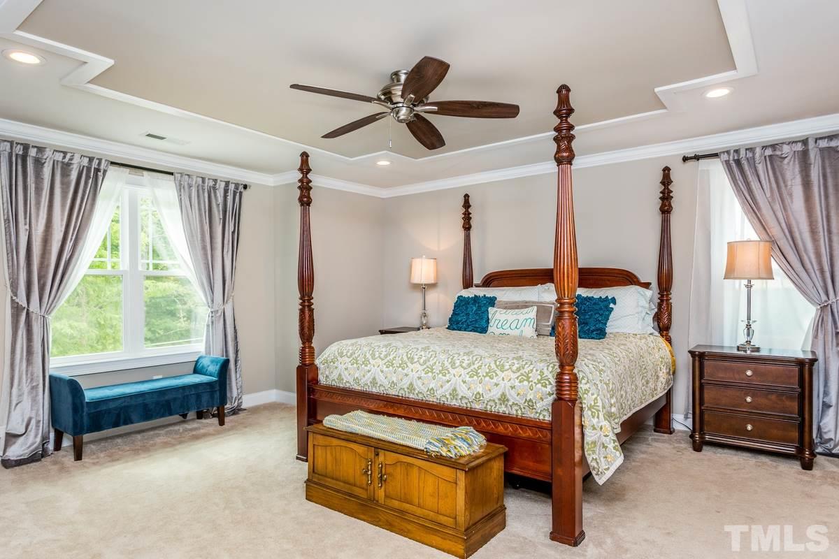 1429 Nottingham Road Raleigh, NC 27607 - Photo 11 of 25 a bedroom with a bed a chandelier and dresser