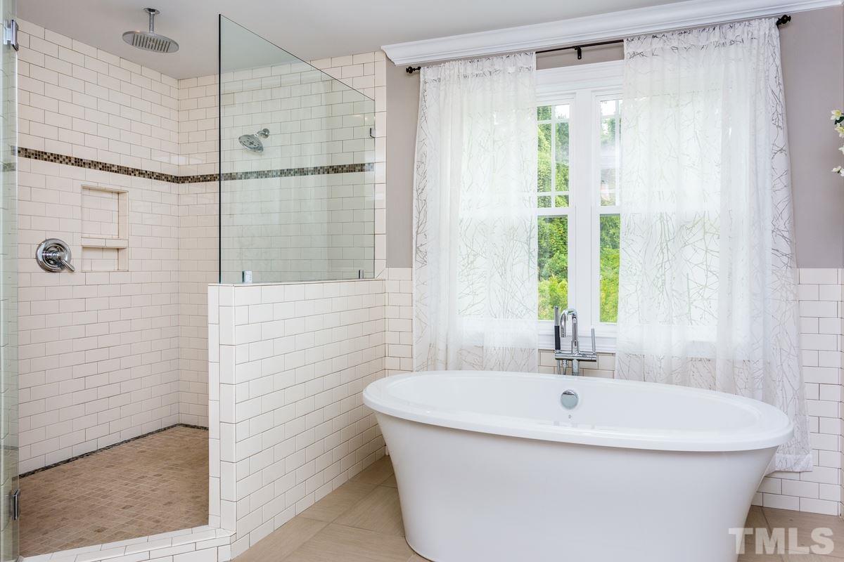 1429 Nottingham Road Raleigh, NC 27607 - Photo 13 of 25 a bathroom with a white bath tub a shower and a sink