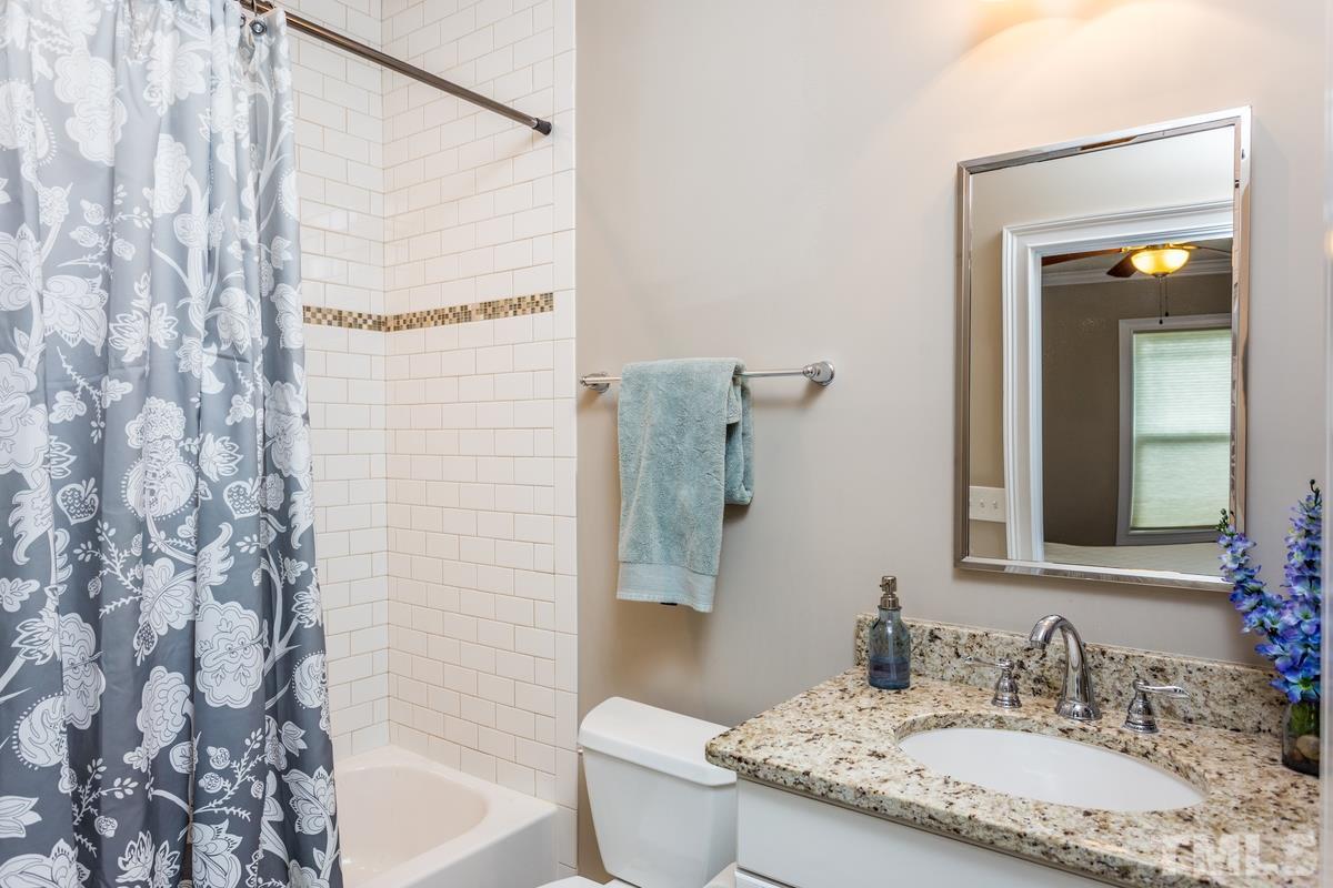 1429 Nottingham Road Raleigh, NC 27607 - Photo 15 of 25 a bathroom with a granite countertop sink and a mirror