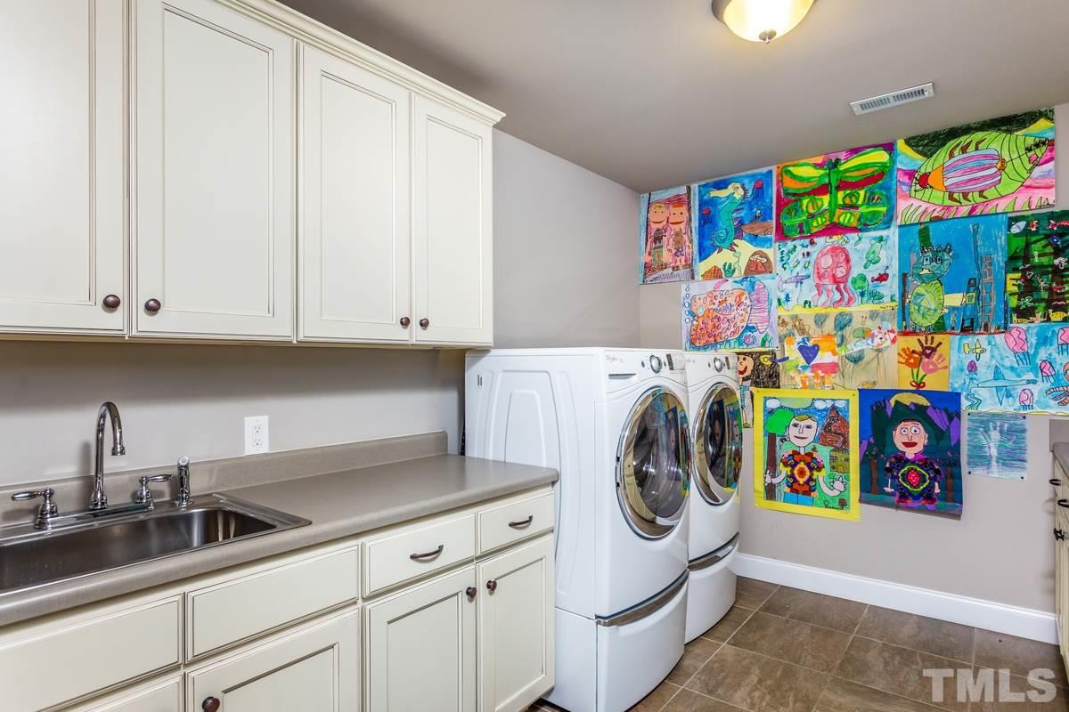 1429 Nottingham Road Raleigh, NC 27607 - Photo 16 of 25 a utility room with fridge and sink