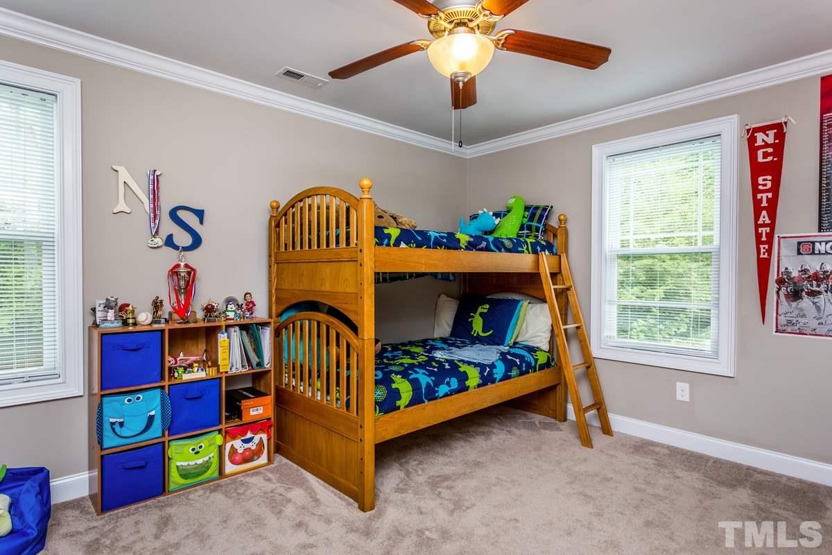 1429 Nottingham Road Raleigh, NC 27607 - Photo 19 of 25 a bedroom with a bed and a baby crib