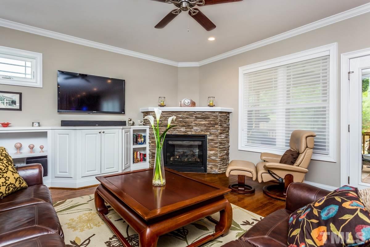 1429 Nottingham Road Raleigh, NC 27607 - Photo 4 of 25 a living room with furniture a flat screen tv and a fireplace