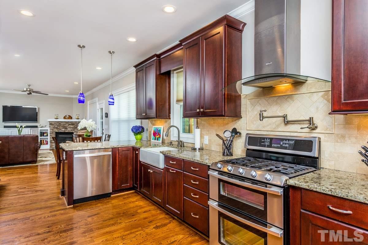 1429 Nottingham Road Raleigh, NC 27607 - Photo 6 of 25 a kitchen with stainless steel appliances granite countertop a stove a sink and a microwave