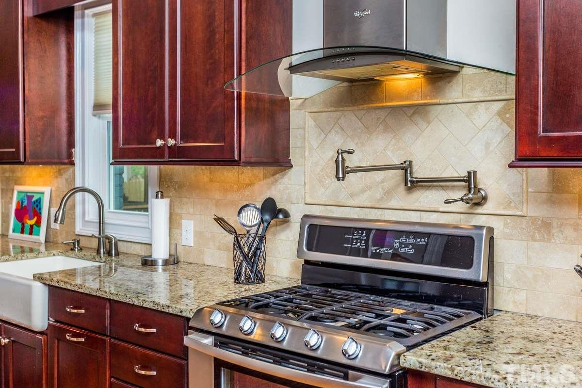 1429 Nottingham Road Raleigh, NC 27607 - Photo 7 of 25 a kitchen with granite countertop a stove and a sink