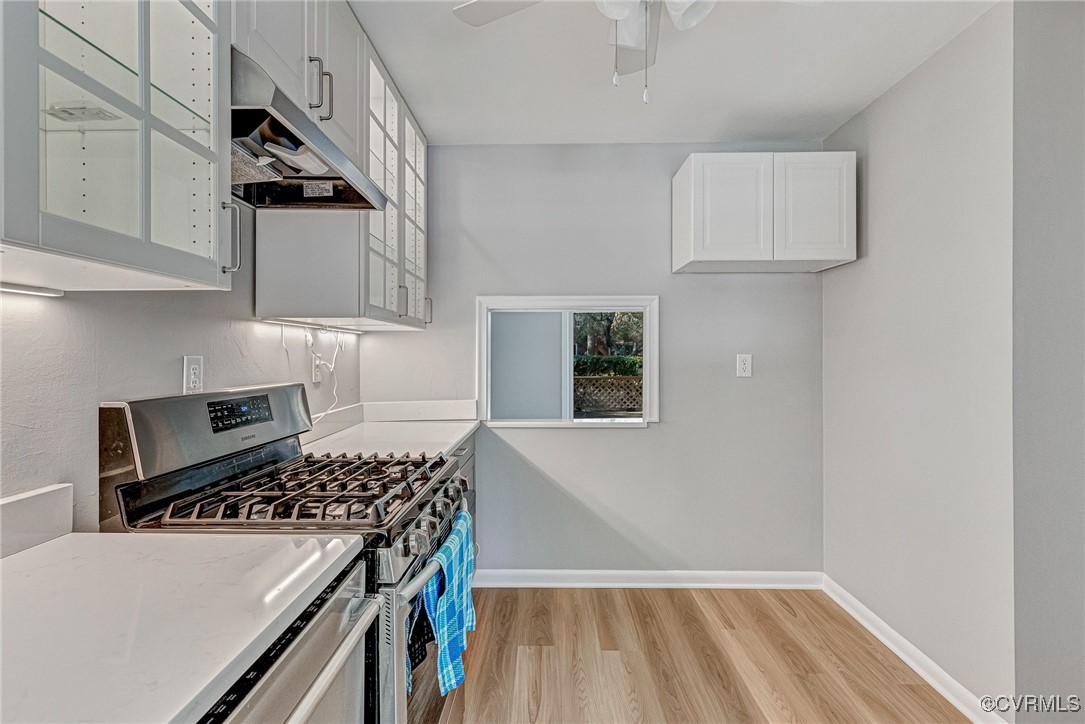 9101 Derbyshire Road, Unit E Henrico, VA 23229 - Photo 14 of 37 Kitchen with white cabinets, light hardwood / wood