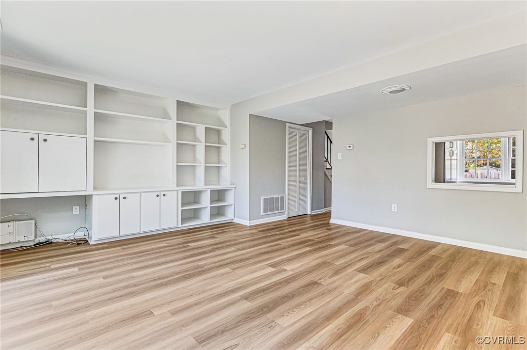 9101 Derbyshire Road, Unit E Henrico, VA 23229 - Photo 4 of 37 Unfurnished living room with light hardwood / wood