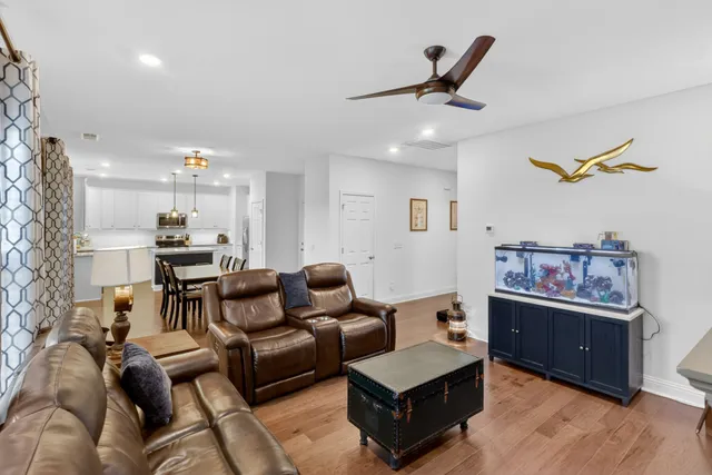 a living room with furniture and kitchen view