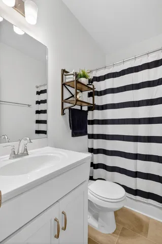 a bathroom with a sink toilet and