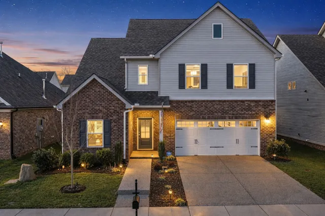 a front view of a house with a yard