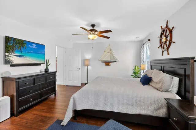 a bedroom with a bed and a flat screen tv