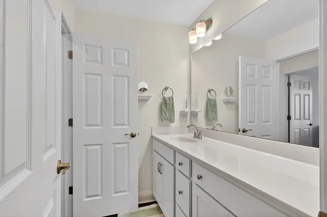 a spacious bathroom with double vanity sinks a vanity two mirror and a shower