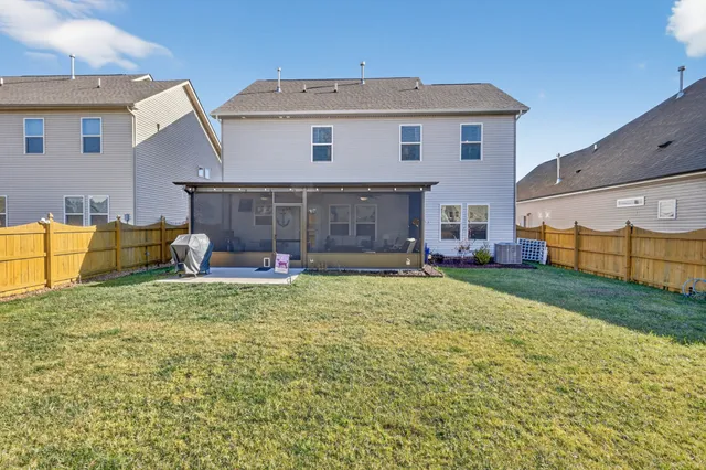a view of a house with a backyard