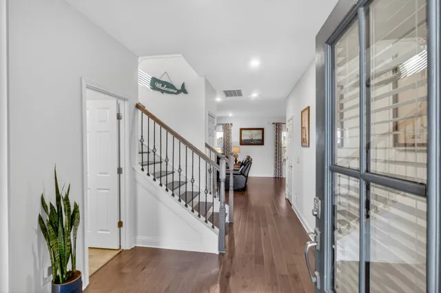 a view of staircase with wooden floor and a potted plant