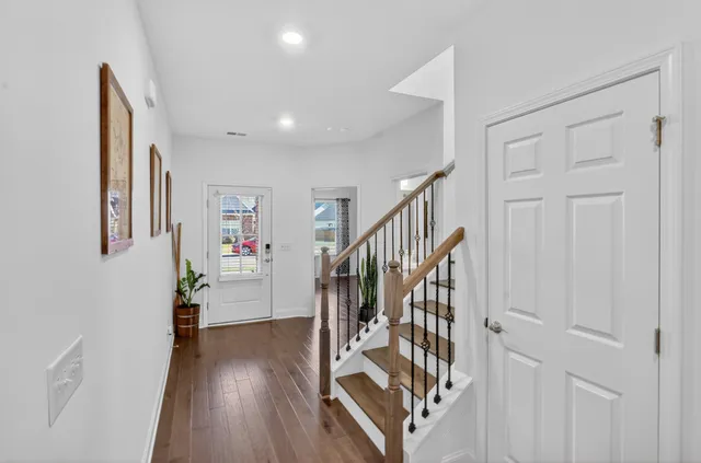 a view of entryway with wooden floor and stairs