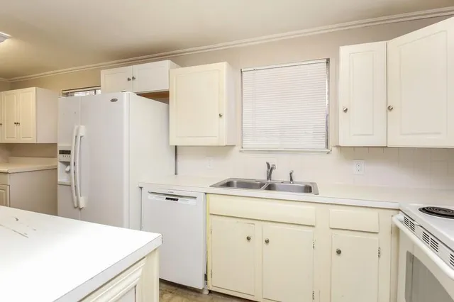 a utility room with cabinets washer and dryer