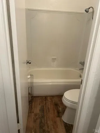a bathroom with a toilet and a bathtub