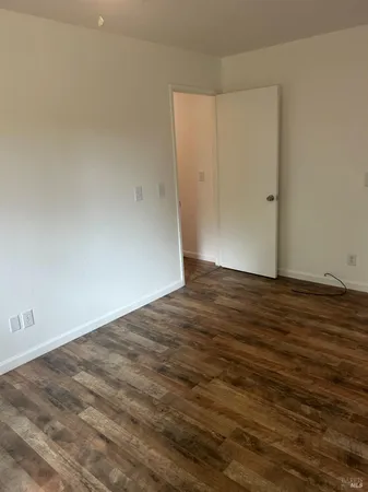 an empty room with wooden floor