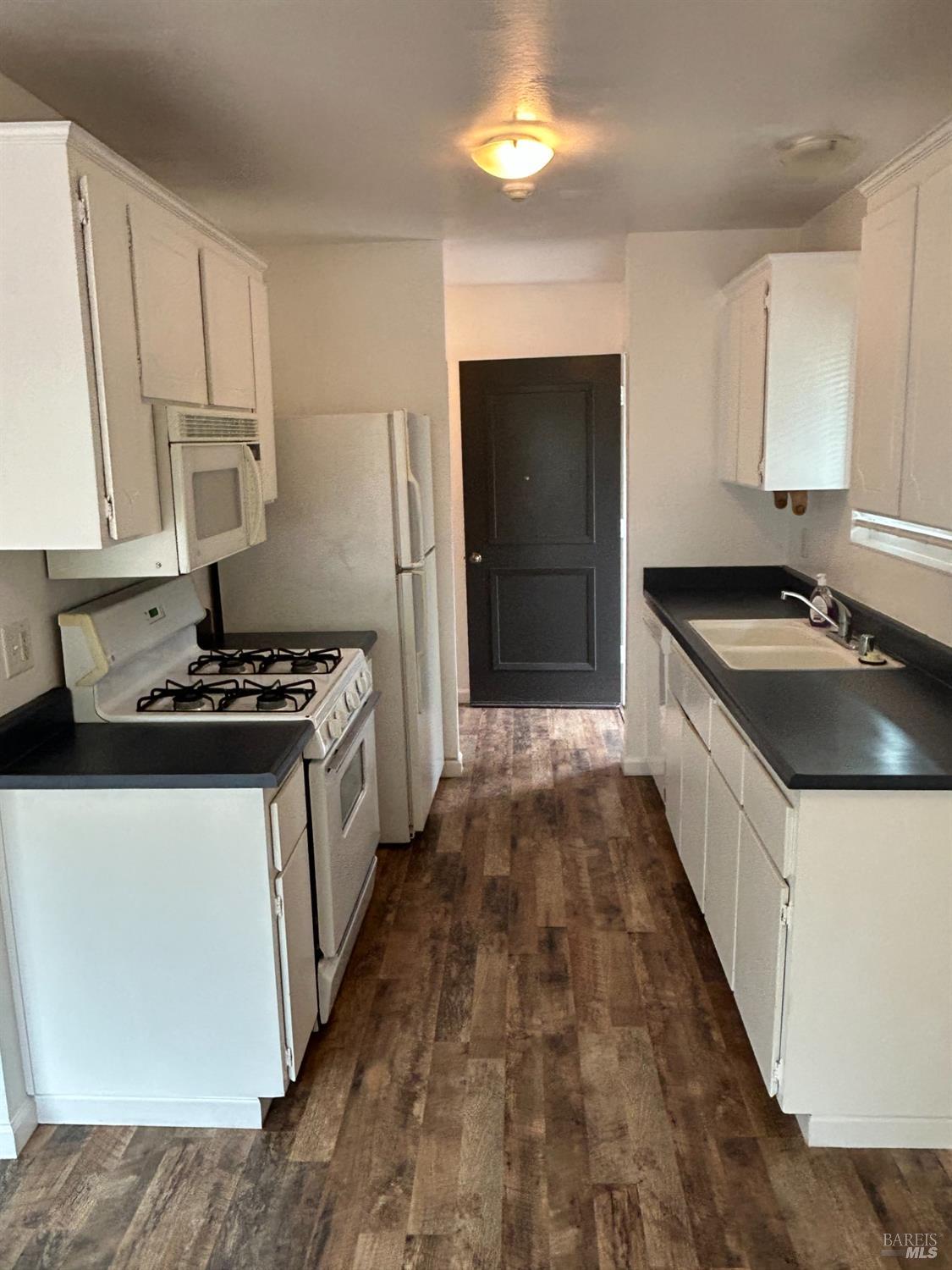 311 Algiers Court Santa Rosa, CA 95409 - Photo 6 of 20 a kitchen with sink a stove and refrigerator