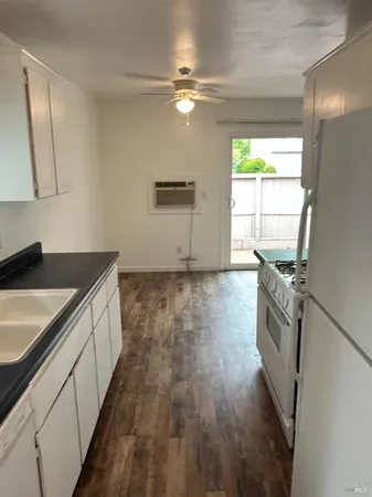 a kitchen with granite countertop a sink and a stove top oven