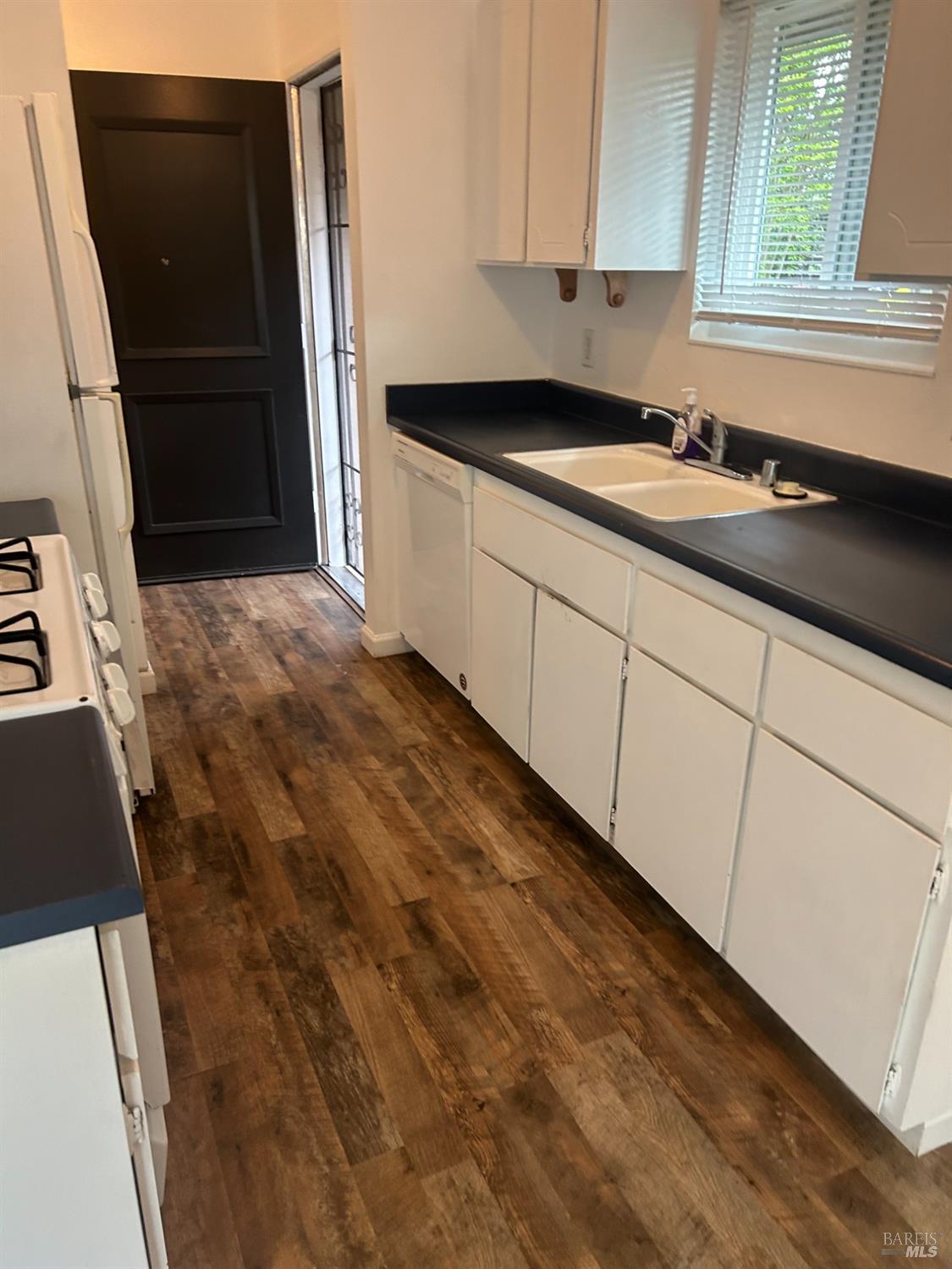 311 Algiers Court Santa Rosa, CA 95409 - Photo 8 of 20 a kitchen with granite countertop a sink and a stove top oven