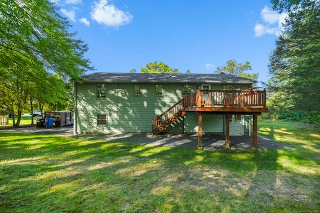 a view of a house with a yard balcony and sitting area