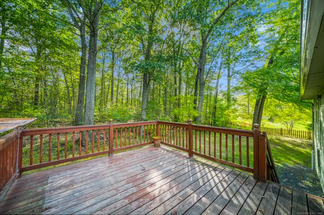 a view of deck with a large trees