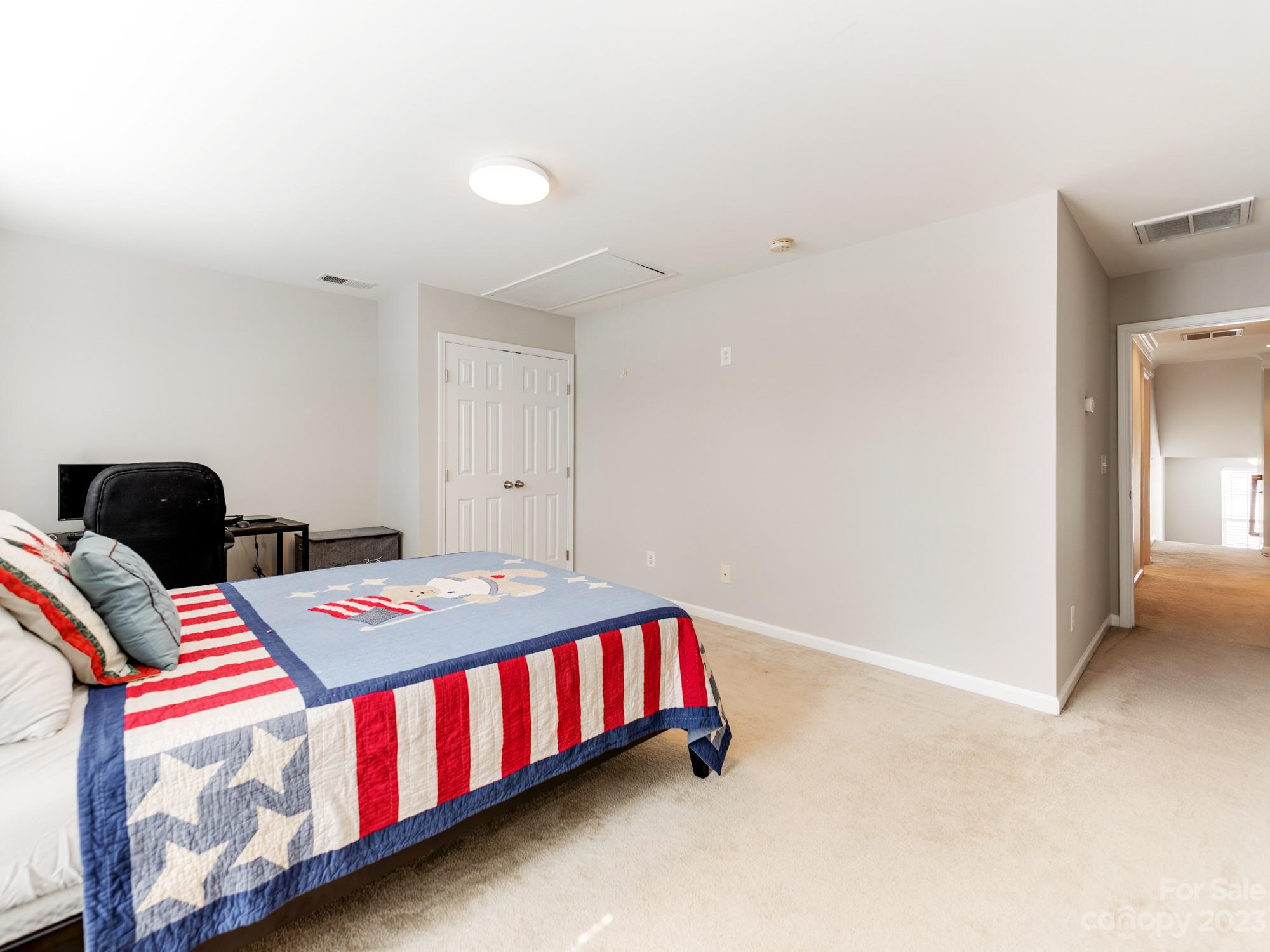 7219 Meyer Road Fort Mill, SC 29715 - Photo 30 of 41 a bedroom with a bed and a chandelier